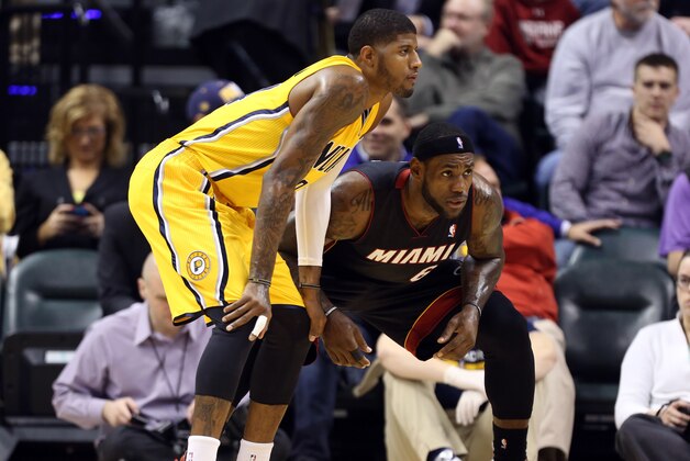 Dec 10, 2013; Indianapolis, IN, USA; Indiana Pacers forward Paul George (24) is guarded by Miami Heat forward LeBron James (6) at Bankers Life Fieldhouse. Mandatory Credit: Brian Spurlock-USA TODAY Sports