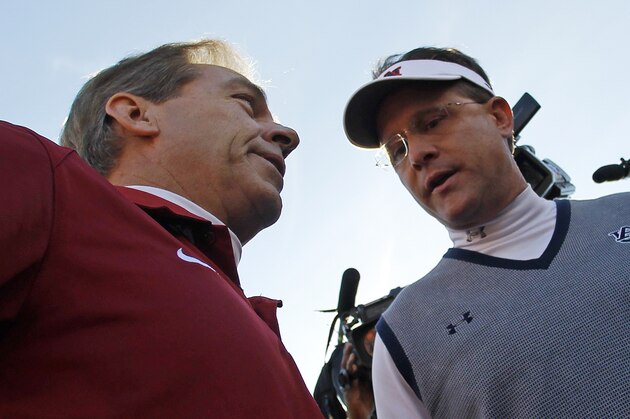 Alabama head coach Nick Saban, left, talks with Auburn head coach Gus Malzahn prior to the start of an NCAA college football game in Auburn, Ala., Saturday, Nov. 30, 2013. (AP Photo/Butch Dill)