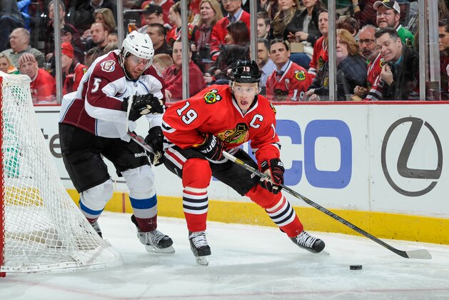 CHICAGO, IL - MARCH 4:  Jonathan Toews #19 of the Chicago Blackhawks controls the puck as Nate Guenin #5 of the Colorado Avalanche trails during the NHL game on March 04, 2014 at the United Center in Chicago, Illinois. (Photo by Bill Smith/NHLI via Getty Images)