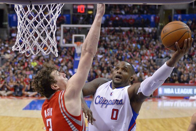 Los Angeles Clippers forward Glen Davis, right, puts up a shot Houston Rockets center Omer Asik, of Turkey, defends during the second half of an NBA basketball game, Wednesday, Feb. 26, 2014, in Los Angeles. (AP Photo/Mark J. Terrill)
