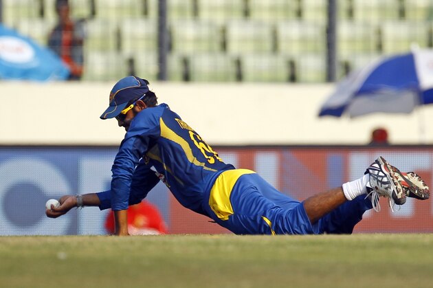 Sri Lanka’s Lahiru Thirimanne catches the ball resulting in the dismissal of Bangladesh’s Anamul Haque during the Asia Cup one-day international cricket tournament in Dhaka, Bangladesh, Thursday, March 6, 2014. (AP Photo/A.M. Ahad)