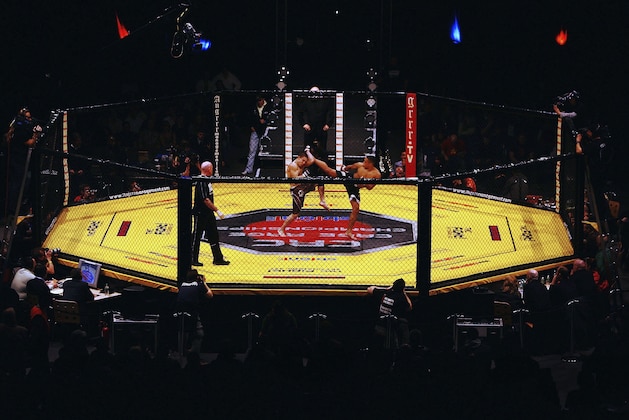 LONDON - FEBRUARY 10: Ashleigh Grimshaw in action against Ronnie Mann during the Cage Rage Championship 20 Born to fight event at Wembley Arena on February 10, 2007 in London, England. Cage Fighting also known as MMA Mixed Martial Arts is a mixed fighting style combat sport with a steadily growing international fan base. MMA is an evolving combat sport where competitors combine different disciplines that include jiu-jitsu, judo, karate, boxing, kickboxing, wrestling and others to their strategic and tactical advantage in a competetive arena.  (Photo by Daniel Berehulak/Getty Images)