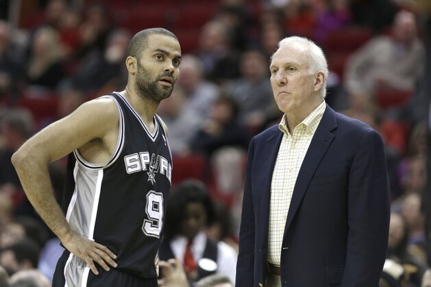 San Antonio Spurs coach Gregg Popovich, right, talks with Tony Parker (9) in the first half of an NBA basketball game against the Houston Rockets Tuesday, Jan. 28, 2014, in Houston. (AP Photo/Pat Sullivan)