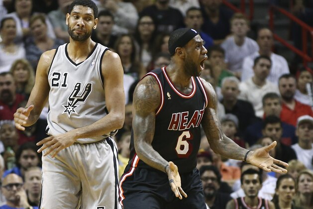 After fouling San Antonio Spurs' Tim Duncan (21), Miami Heat's LeBron James (6) reacts as he is charged with a technical foul also, during the second half of an NBA basketball game in Miami, Sunday, Jan. 26, 2014. The Heat won 113-101. (AP Photo/J Pat Carter)