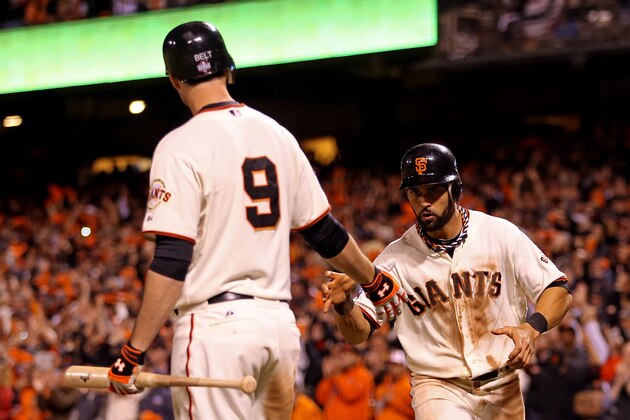 SAN FRANCISCO, CA - OCTOBER 25:  (L-R) Brandon Belt #9 of the San Francisco Giants greets Angel Pagan #16 after Pagan scored on a sacrifice fly hit by Hunter Pence #8 in the eighth inning against the Detroit Tigers during Game Two of the Major League Baseball World Series at AT&T Park on October 25, 2012 in San Francisco, California.  (Photo by Christian Petersen/Getty Images)