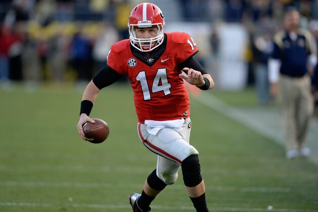 FILE - In this Nov. 30, 2013 file photo, Georgia quarterback Hutson Mason (14) scrambles for a first down against Georgia Tech during the first half of an NCAA football game in Atlanta. With the drama of his first career start behind him, Mason can use practice for No. 23 Georgia's Gator Bowl game against Nebraska as preparation for his expected full season as a starter in 2014.  (AP Photo/David Tulis, File)