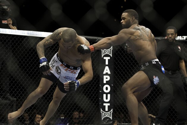 Tyron Woodley trades punches with Jay Hieron during their UFC 156 welterweight mixed martial arts match, Saturday, Feb. 2, 2013 at The Mandalay Bay Resort & Casino in Las Vegas. (AP Photo/Eric Jamison) Tyron Woodley trades punches with Jay Hieron during their UFC 156 welterweight mixed martial arts match, Saturday, Feb. 2, 2013 at The Mandalay Bay Resort & Casino in Las Vegas. (AP Photo/Eric Jamison)