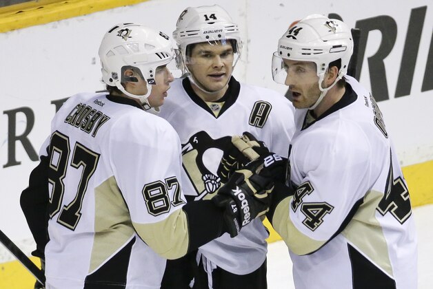 Pittsburgh Penguins' Chris Kunitz (14) is congratulated by Sidney Crosby (87) and Brooks Orpik (44) after Kunitz scored against the Nashville Predators in the third period of an NHL hockey game Tuesday, March 4, 2014, in Nashville, Tenn. (AP Photo/Mark Humphrey)