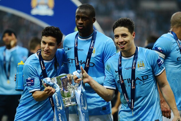 LONDON, ENGLAND - MARCH 02:  (L-R) Jesus Navas, Yaya Toure and Samir Nasri of Manchester City pose with the trophy after the Capital One Cup Final between Manchester City and Sunderland at Wembley Stadium on March 2, 2014 in London, England.  (Photo by Jamie McDonald/Getty Images)