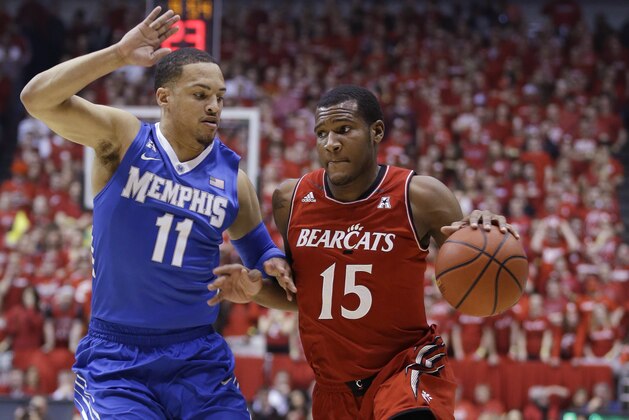 Cincinnati forward Jermaine Sanders (15) drives against Memphis guard Michael Dixon Jr. (11) in the first half of an NCAA college basketball game, Thursday, March 6, 2014, in Cincinnati. (AP Photo/Al Behrman)