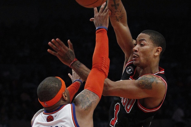 Chicago Bulls' Derrick Rose passes over New York Knicks' Carmelo Anthony (7) during the second half of an NBA basketball game Tuesday, April 12, 2011, in New York. The Bulls won 103-90. (AP Photo/Frank Franklin II)