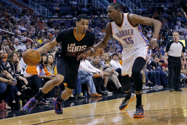 Phoenix Suns' Gerald Green drives past Oklahoma City Thunder forward Kevin Durant (35) during the second half of an NBA basketball game, Thursday, March 6, 2014, in Phoenix. The Suns won 128-122. (AP Photo/Matt York)