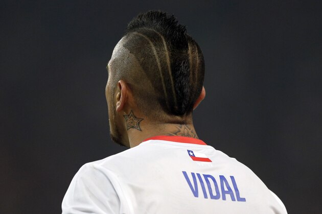 Chile's Arturo Vidal watches his team mates during the international friendly soccer match between Germany and Chile in Stuttgart, Germany, Wednesday, March 5, 2014. (AP Photo/Matthias Schrader)