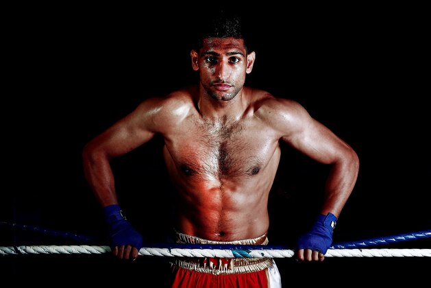 BOLTON, ENGLAND - APRIL 22:  Amir Khan poses during a photo shoot at Gloves Gym on April 22, 2013 in Bolton, England.  (Photo by Scott Heavey/Getty Images)