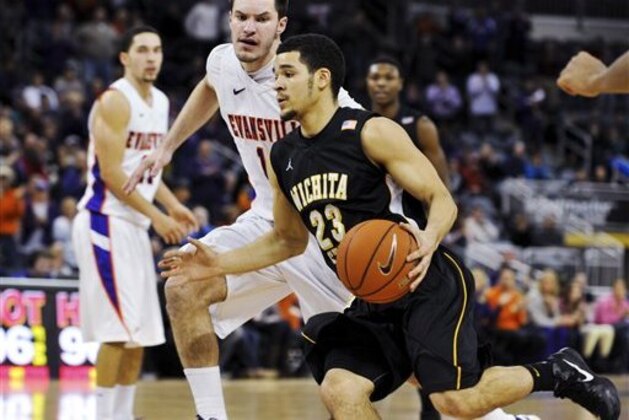 Wichita State's Fred Van Vleet (23) drive to the basket as Evansville's Jordan Jahr (13) defends during the second half of their NCAA college basketball game, Sunday, Jan. 13, 2013, in Evansville, Ind. Evansville won 71-67. (AP Photo/Daniel R. Patmore)