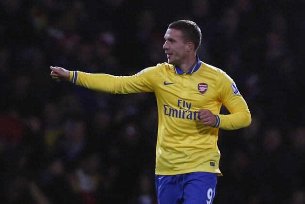 Arsenal's Lukas Podolski celebrates his goal against West Ham United during their English Premier League soccer match at Upton Park, London, Thursday, Dec. 26, 2013. (AP Photo/Sang Tan)