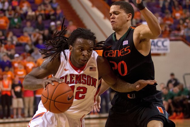 Mar 4, 2014; Clemson, SC, USA; Clemson Tigers guard Rod Hall (12) drives to the basket while being defended by Miami Hurricanes guard Manu Lecomte (20) during the second half at J.C. Littlejohn Coliseum. Tigers won 58-54. Mandatory Credit: Joshua S. Kelly-USA TODAY Sports