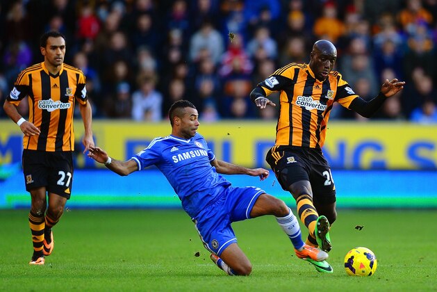 HULL, ENGLAND - JANUARY 11:  Ashley Cole of Chelsea tackles Yannick Sagbo of Hull City during the Barclays Premier League match between Hull City and Chelsea at KC Stadium on January 11, 2014 in Hull, England.  (Photo by Laurence Griffiths/Getty Images)