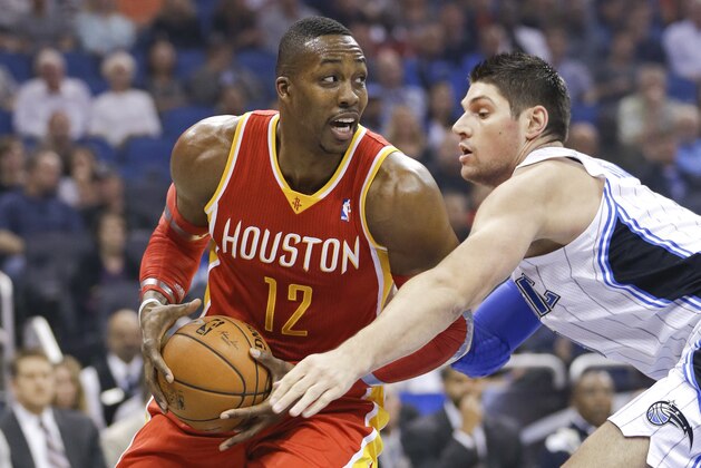 Houston Rockets' Dwight Howard (12) looks for a way around Orlando Magic's Nikola Vucevic during the first half of an NBA basketball game in Orlando, Fla., Wednesday, March 5, 2014. (AP Photo/John Raoux) Houston Rockets' Dwight Howard (12) looks for a way around Orlando Magic's Nikola Vucevic during the first half of an NBA basketball game in Orlando, Fla., Wednesday, March 5, 2014. (AP Photo/John Raoux)