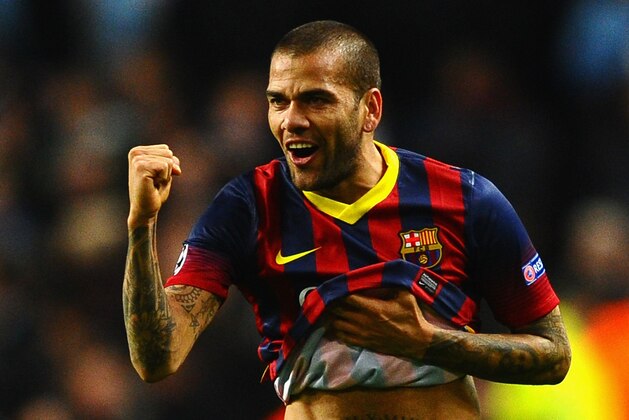 MANCHESTER, ENGLAND - FEBRUARY 18:  Daniel Alves of Barcelona celebrates scoring his team's second goal during the UEFA Champions League Round of 16 first leg match between Manchester City and Barcelona at the Etihad Stadium on February 18, 2014 in Manchester, England.  (Photo by Laurence Griffiths/Getty Images)