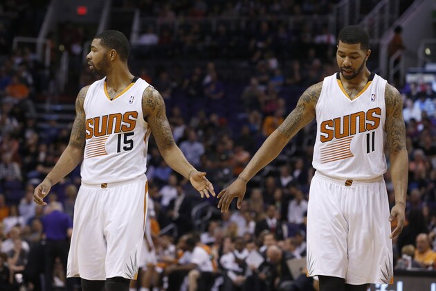 Phoenix Suns' Marcus Morris (15) and Markieff Morris (11) shake hands during the first half of an NBA basketball game against the Miami Heat Tuesday, Feb. 11, 2014, in Phoenix.  The Heat defeated the Suns 103-97. (AP Photo/Ross D. Franklin)