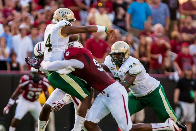 September 15, 2012; Columbia, SC, USA; South Carolina Gamecocks defensive end Darius English (8) hits UAB Blazers quarterback Jonathan Perry (14) as he throws in the first half at Williams-Brice Stadium. Mandatory Credit: Jeff Blake-USA TODAY Sports