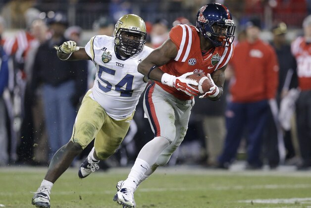 Mississippi wide receiver Laquon Treadwell, right, makes a catch in front of Georgia Tech linebacker Quayshawn Nealy (54) for a 27-yard gain in the fourth quarter of the NCAA college football Music City Bowl on Monday, Dec. 30, 2013, in Nashville, Tenn. Mississippi won 25-17. (AP Photo/Mark Humphrey)