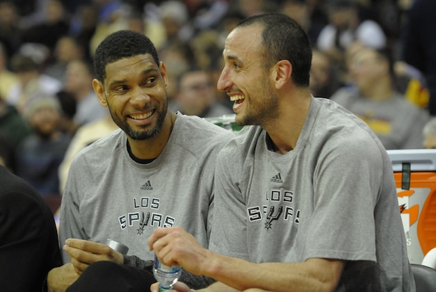 Mar 4, 2014; Cleveland, OH, USA; San Antonio Spurs power forward Tim Duncan (left) and shooting guard Manu Ginobili (20) laugh on the bench in the fourth quarter of a 122-101 win over the Cleveland Cavaliers at Quicken Loans Arena. Mandatory Credit: David Richard-USA TODAY Sports