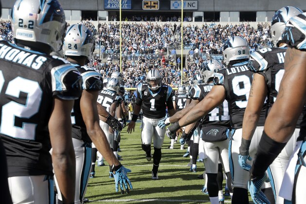 Carolina Panthers' Cam Newton (1) greets his teammates during the introductions for the offense before an NFL football game against the Tampa Bay Buccaneers in Charlotte, N.C., Sunday, Dec. 1, 2013. The Panthers won 27-6. (AP Photo/Bob Leverone)