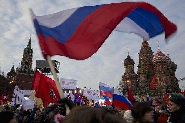 Pro-Putin demonstrators wave Russian national flags as they gather towards to Red Square in Moscow, Russia, Friday, March 7, 2014, with Spassky Tower, left, and St. Basile Cathedral, right, are in the background. Russia rallied support Friday for a Crimean bid to secede from Ukraine, with a leader of Russia’s parliament assuring her Crimean counterpart that the region would be welcomed as “an absolutely equal subject of the Russian Federation.” Across Red Square, 65,000 people waved Russian flags, chanting “Crimea is Russia!”(AP Photo/Alexander Zemlianichenko)