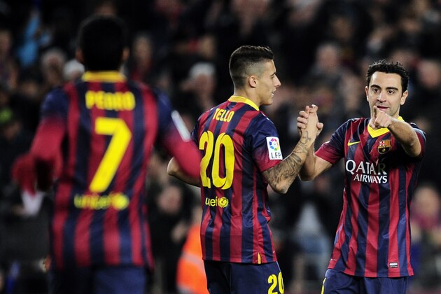 FC Barcelona's Xavi Hernandez, right, reacts after scoring against Almeria during a Spanish La Liga soccer match at the Camp Nou stadium in Barcelona, Spain, Sunday, March 2, 2014. (AP Photo/Manu Fernandez)