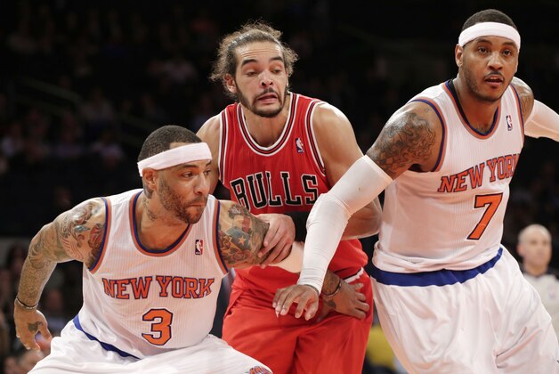 New York Knicks forward Kenyon Martin (3) and New York Knicks forward Carmelo Anthony (7) defend Chicago Bulls center Joakim Noah (13) on a rebound in the second half of their NBA basketball game at Madison Square Garden in New York, Wednesday, Dec. 11, 2013.  (AP Photo/Kathy Willens)