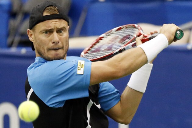 Lleyton Hewitt, of Australia, watches the ball as he hits a return to Michael Russell in the quarterfinal match at the U.S. National Indoor Tennis Championships, Friday, Feb. 14, 2014 in Memphis, Tenn. (AP Photo/Rogelio V. Solis)