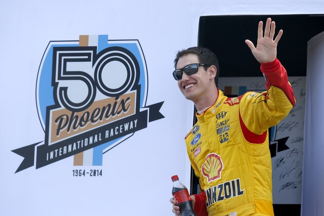 Joey Logano waves to the crowd during driver introductions prior to the NASCAR Sprint Cup Series auto race Sunday, March 2, 2014, in Avondale, Ariz. (AP Photo/Ross D. Franklin)