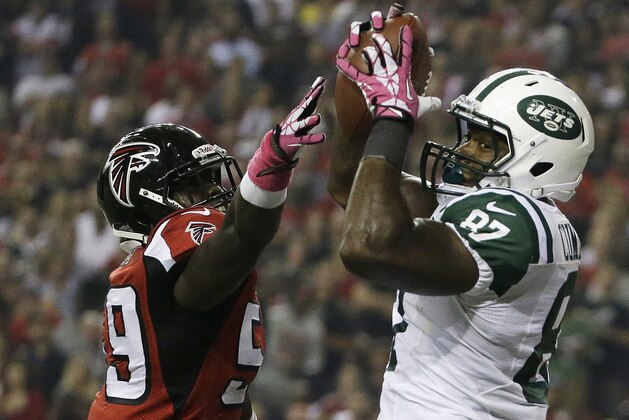 New York Jets tight end Jeff Cumberland (87) catches the ball for a touchdown against Atlanta Falcons outside linebacker Joplo Bartu (59) during the first half of an NFL football game, Monday, Oct. 7, 2013, in Atlanta. (AP Photo/David Goldman)
