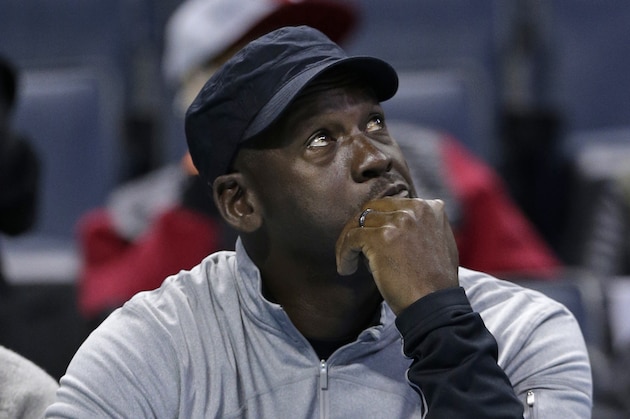Charlotte Bobcats owner Michael Jordan looks at the scoreboard during the first half of an NBA basketball game against the Washington Wizards in Charlotte, N.C., Tuesday, Jan. 7, 2014. (AP Photo/Chuck Burton)