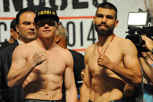 Mar 7, 2014; Las Vegas, NV, USA; Saul Canelo Alvarez (left) and Alfredo Angulo pose for photographers during a weigh-in before their super welterweight bout at MGM Grand Garden Arena. Mandatory Credit: Stephen R. Sylvanie-USA TODAY Sports