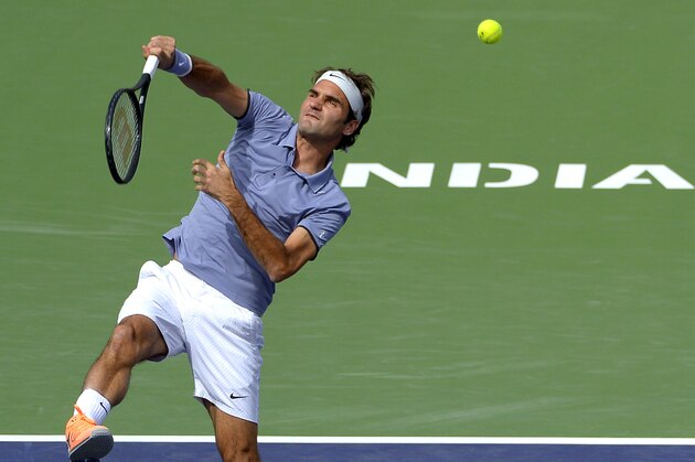 Roger Federer, of Switzerland, right, returns a volley during a match with doubles partner Stanislas Wawrinka, (not shown) at the BNP Paribas Open tennis tournament against Rohan Bopanna, of India, and Aisam-Ul-Haq Qureshi, of Pakistan,  Friday, March 7, 2014 in Indian Wells, Calif. (AP Photo/Mark J. Terrill)