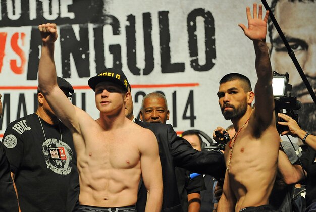 Mar 7, 2014; Las Vegas, NV, USA; Saul Canelo Alvarez (left) and Alfredo Angulo salute fans after participating in the official weigh-in before their super welterweight bout at MGM Grand Garden Arena. Mandatory Credit: Stephen R. Sylvanie-USA TODAY Sports Mar 7, 2014; Las Vegas, NV, USA; Saul Canelo Alvarez (left) and Alfredo Angulo salute fans after participating in the official weigh-in before their super welterweight bout at MGM Grand Garden Arena. Mandatory Credit: Stephen R. Sylvanie-USA TODAY Sports