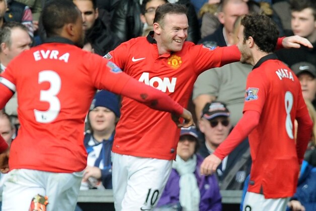 Manchester United's Wayne Rooney celebrates with Juan mata, right, and Patrice Evra after scoring against West Brom during the English Premier League soccer match between West Bromwich Albion and Manchester United at The Hawthorns Stadium in West Bromwich, England, Saturday, March 8, 2014.  (AP Photo/Rui Vieira)