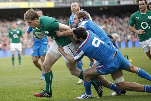 Ireland's Andrew Trimble, left, breaks through to score a try despite being tackled by Italy's Tito Tebaldi, right, and Joshua Raffaele Furno during their Six Nations Rugby Union international match at the Aviva Stadium, Dublin, Ireland, Saturday, March 8, 2014.  (AP Photo/Peter Morrison)