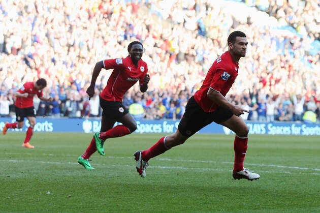 CARDIFF, WALES - MARCH 08:  Steven Caulker of Cardiff City (R) celebrates with Kenwyne Jones as he scores their second goal during the Barclays Premier League match between Cardiff City and Fulham at Cardiff City Stadium on March 8, 2014 in Cardiff, Wales.  (Photo by Scott Heavey/Getty Images)
