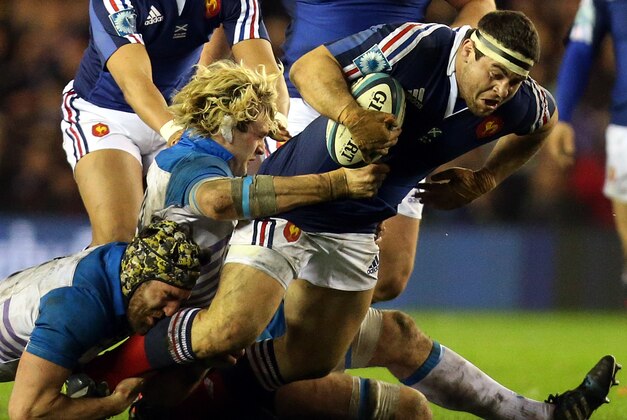 France's Guilhem Guirado, right, is tackled by Scotland's Richie Gray, center, and Kelly Brown during their Six Nations rugby union international match at Murrayfield in Edinburgh, Scotland, Saturday March 8, 2014. (AP Photo/Scott Heppell)