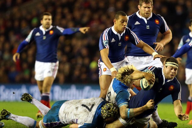 France's Guilhem Guirado, right, is tackled by Scotland's Richie Gray, center, and Kelly Brown during their Six Nations rugby union international match at Murrayfield in Edinburgh, Scotland, Saturday March 8, 2014. (AP Photo/Scott Heppell)