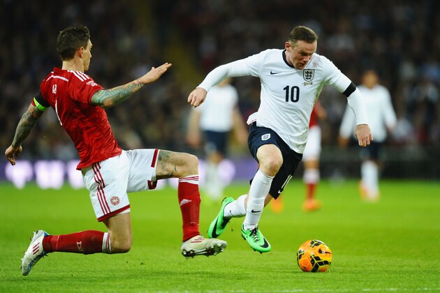 LONDON, ENGLAND - MARCH 05: Wayne Rooney of England goes past Daniel Agger of Denmark during the International Friendly match between England and Denmark at Wembley Stadium on March 5, 2014 in London, England.  (Photo by Laurence Griffiths/Getty Images)