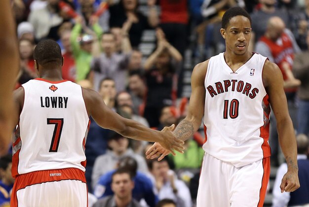 Mar 2, 2014; Toronto, Ontario, CAN; Toronto Raptors guard DeMar DeRozan (10) celebrates a basket with point guard Kyle Lowry (7) against the Golden State Warriors at Air Canada Centre. The Raptors beat the Warriors 104-98. Mandatory Credit: Tom Szczerbowski-USA TODAY Sports