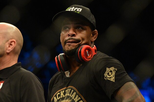 Dec 28, 2013; Las Vegas, NV, USA;    Michael Johnson (blue gloves) wins his UFC Featherweight Bout against Gleison Tibau (red gloves) at the MGM Grand Garden Arena. Johnson won the fight. Mandatory Credit: Jayne Kamin-Oncea-USA TODAY Sports