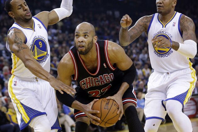 Chicago Bulls' Taj Gibson (22) in action against Golden State Warriors' Andre Iguodala (9), and Marreese Speights, right, during an NBA basketball game on Thursday, Feb. 6, 2014, in Oakland, Calif. (AP Photo/Marcio Jose Sanchez)