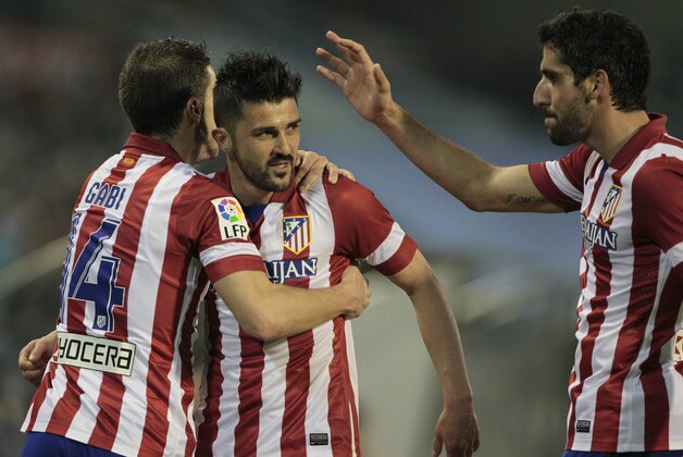 Atletico's David Villa, center, celebrates scoring the first goal against Real Club Celta with his teammates during a Spanish La Liga soccer match at the Balaidos stadium in Vigo, Spain, Saturday, March 8, 2014. (AP Photo/Lalo R. Villar)