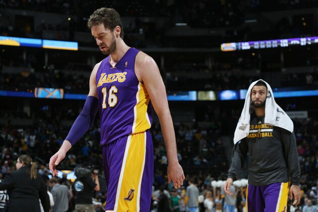 Los Angeles Lakers center Pau Gasol, left, of Spain, and guard Kendall Marshall head off the court after the Denver Nuggets' 134-126 victory over the Lakers in an NBA basketball game in Denver on Friday, March 7, 2014. (AP Photo/David Zalubowski)